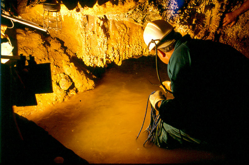 Cango sump Mike Schultz on rope tender February 1980
