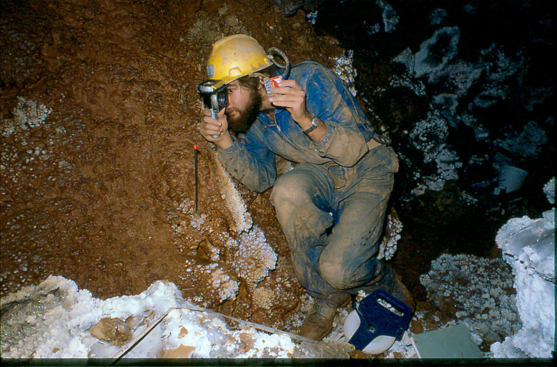 Dave Crombie surveying in stream passage under Krakatoa Cang