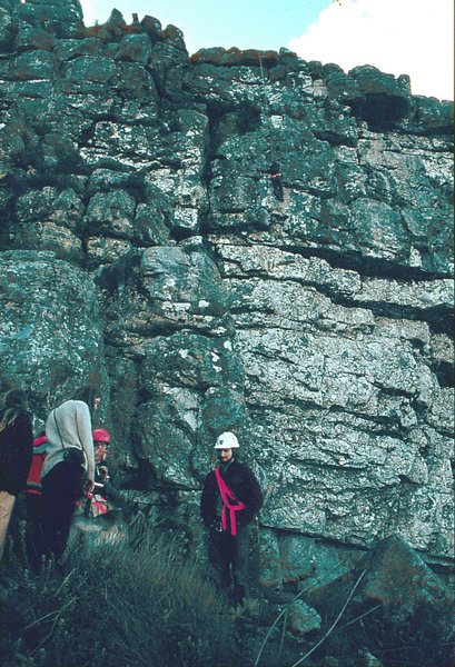 Apple with Stan Walker abseiling in the background   Kalk Bay